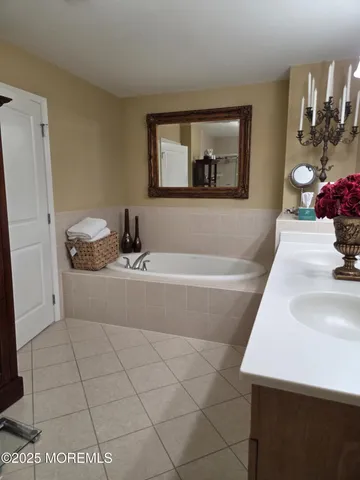 a bathroom with a sink a mirror and shower