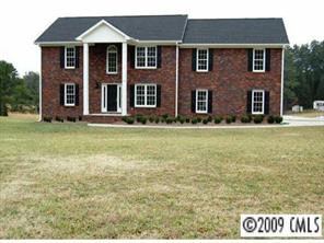 6250 Cress Road Concord, NC 28025 - Photo 1 of 8 a front view of a house with a garden