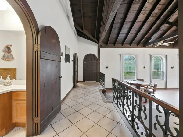 a view of staircase with two chair and a large window