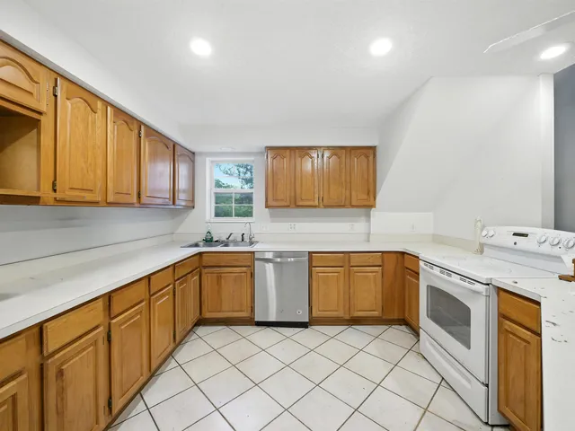 a kitchen with stainless steel appliances granite countertop a sink and cabinets