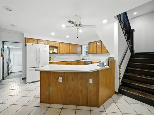 a view of kitchen with sink microwave and refrigerator