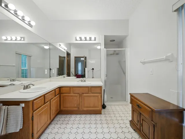 a spacious bathroom with a sink a vanity and a mirror