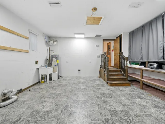 a view of room with stairs and windows