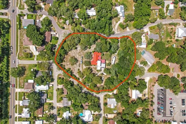 an aerial view of residential houses with yard
