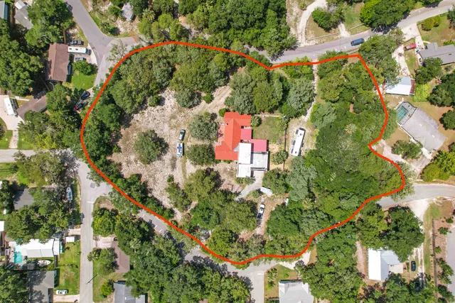 an aerial view of residential houses with outdoor space
