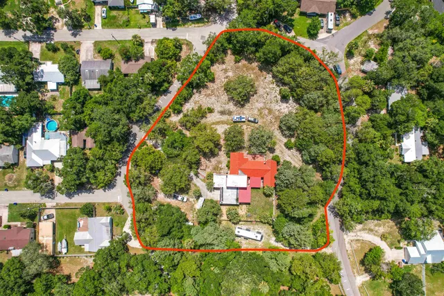 an aerial view of residential houses with outdoor space and street view