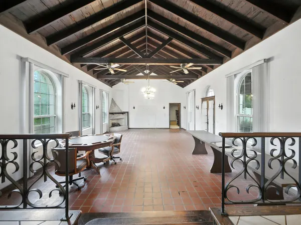 a view of an chairs and table in the room