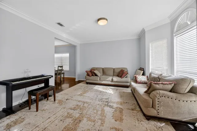 a living room with furniture and a piano