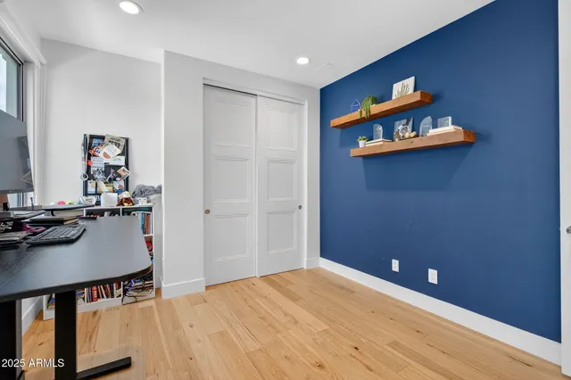 a room with a flat screen tv and a window