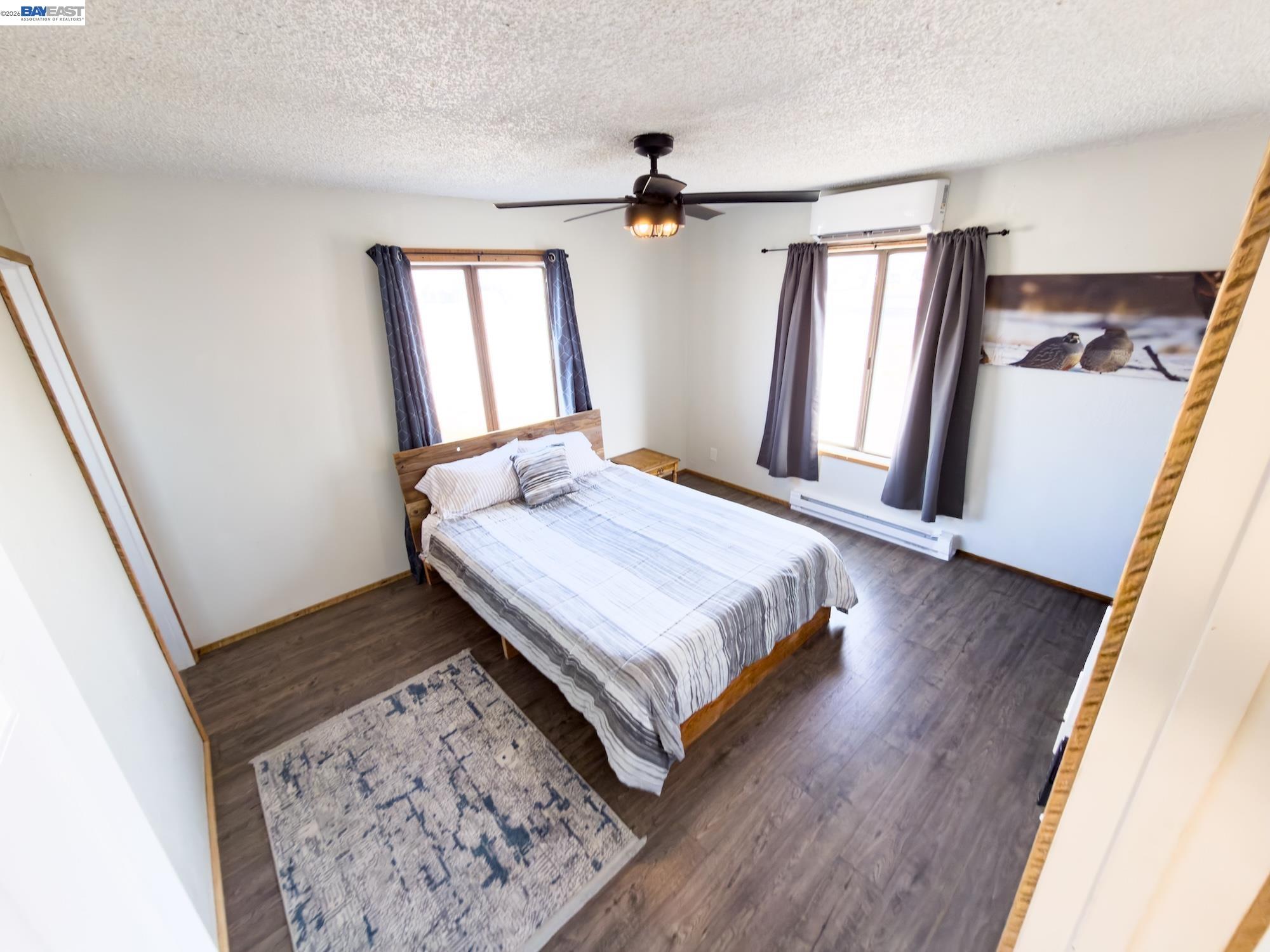 609 East 7th Street Alturas, CA 96101 - Photo 11 of 21 a bedroom with a bed and a mirror on the dresser