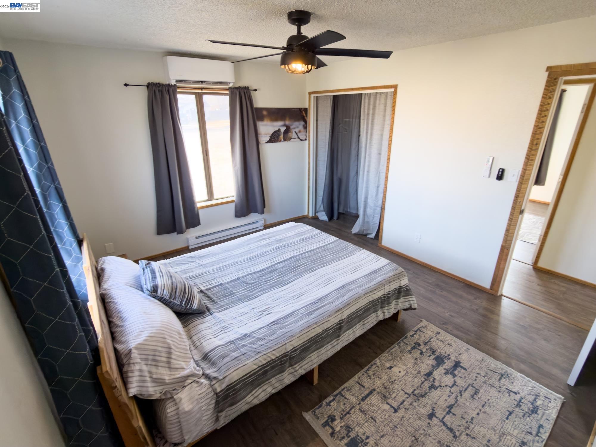 609 East 7th Street Alturas, CA 96101 - Photo 14 of 21 a bedroom with a bed and wooden floor