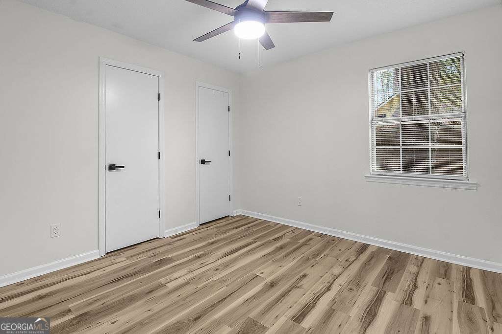 804 Ridgewood Way Hinesville, GA 31313 - Photo 13 of 27 a view of empty room with wooden floor and fan
