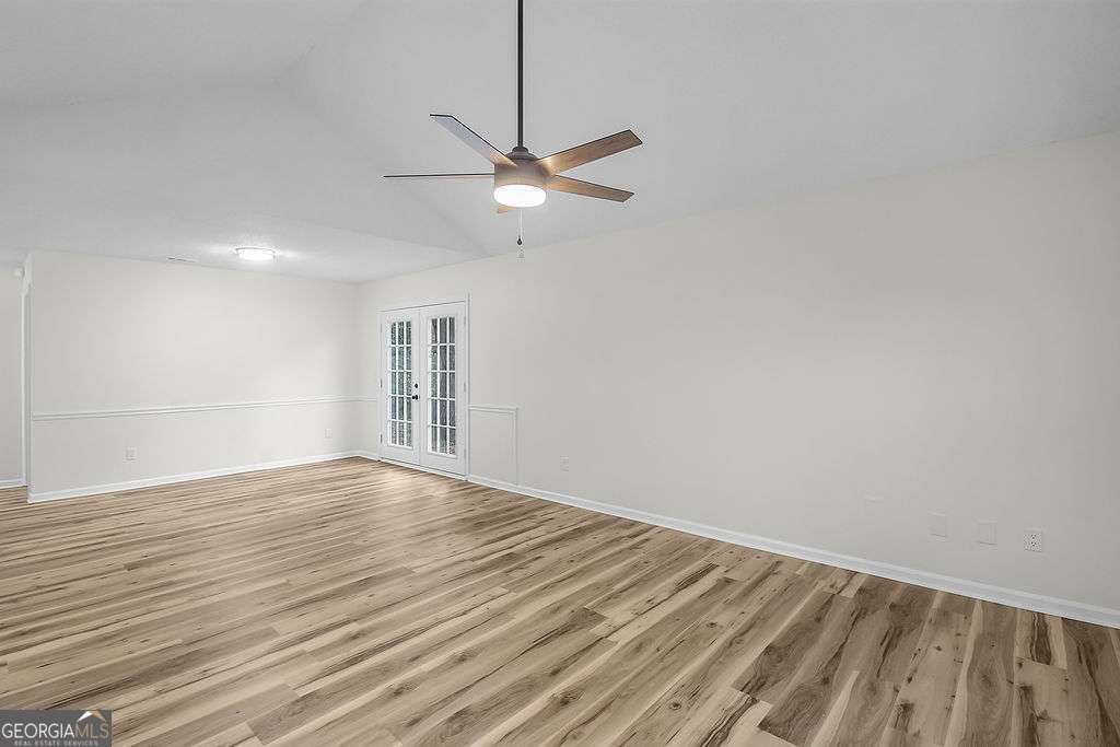 804 Ridgewood Way Hinesville, GA 31313 - Photo 2 of 27 a view of empty room with wooden floor and fan