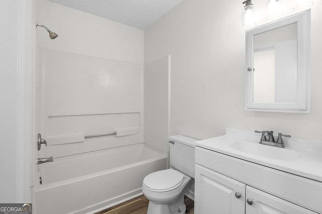 804 Ridgewood Way Hinesville, GA 31313 - Photo 26 of 27 a bathroom with a sink a toilet and shower