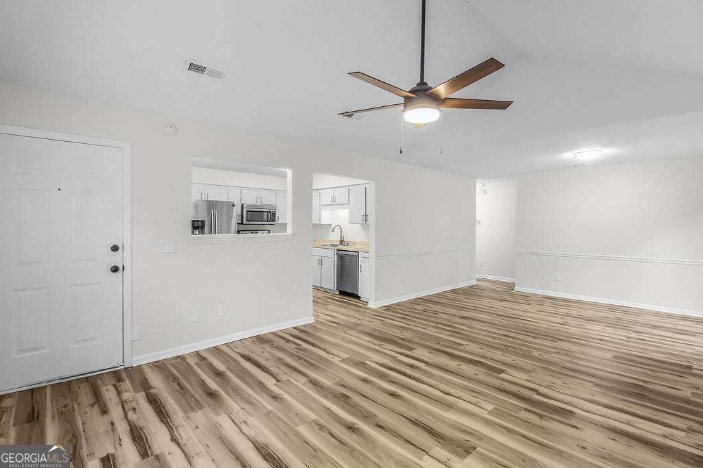 804 Ridgewood Way Hinesville, GA 31313 - Photo 3 of 27 a view of empty room with wooden floor and fan