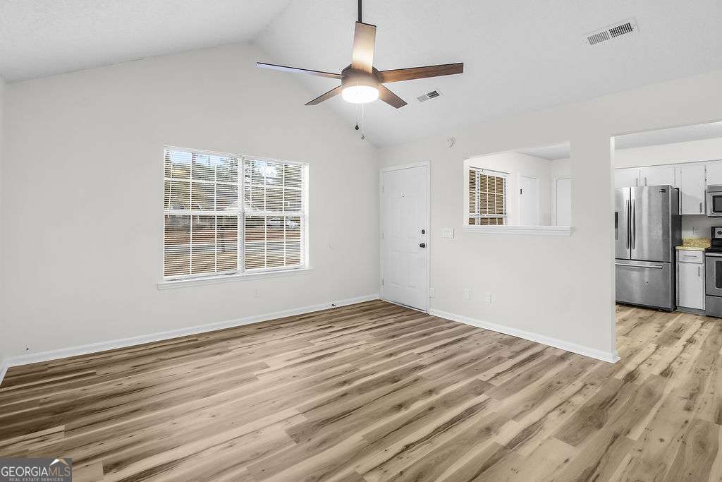804 Ridgewood Way Hinesville, GA 31313 - Photo 4 of 27 a view of empty room with wooden floor and ceiling fan