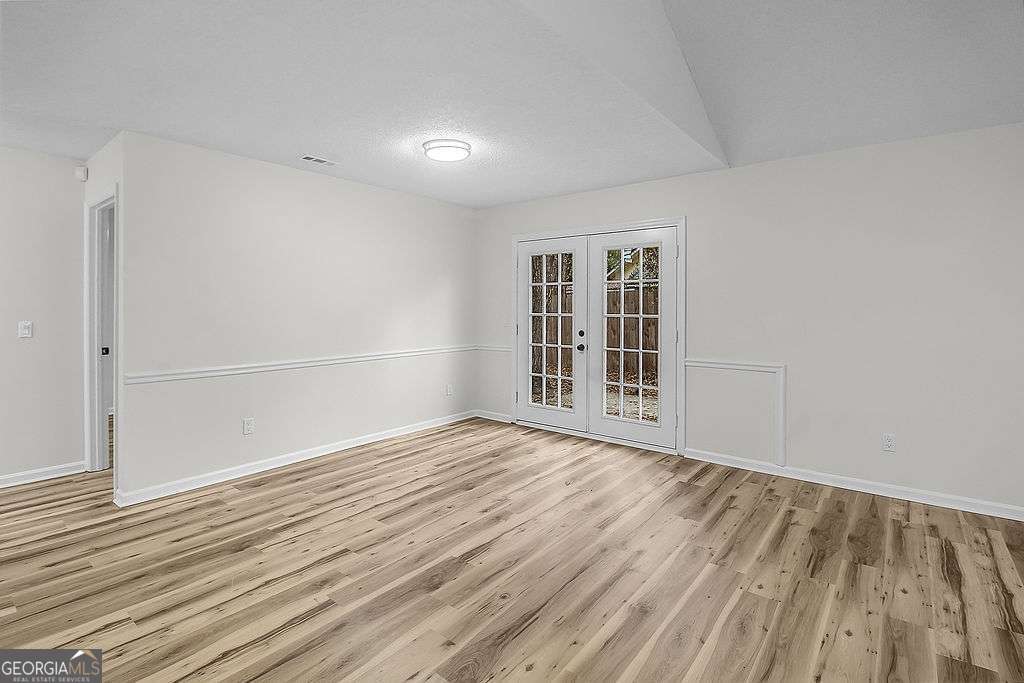 804 Ridgewood Way Hinesville, GA 31313 - Photo 6 of 27 wooden floor in an empty room with a window