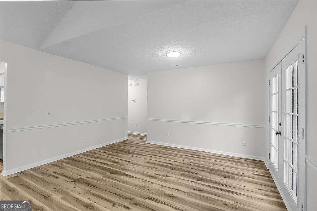 804 Ridgewood Way Hinesville, GA 31313 - Photo 7 of 27 a view of a room with wooden floor and white walls