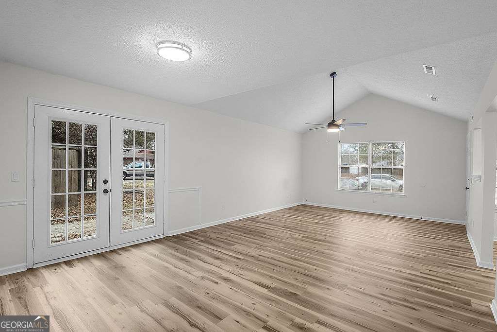 804 Ridgewood Way Hinesville, GA 31313 - Photo 8 of 27 a view of an empty room with a window and wooden floor