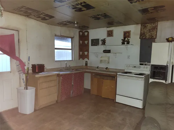 a kitchen with granite countertop a sink and cabinets