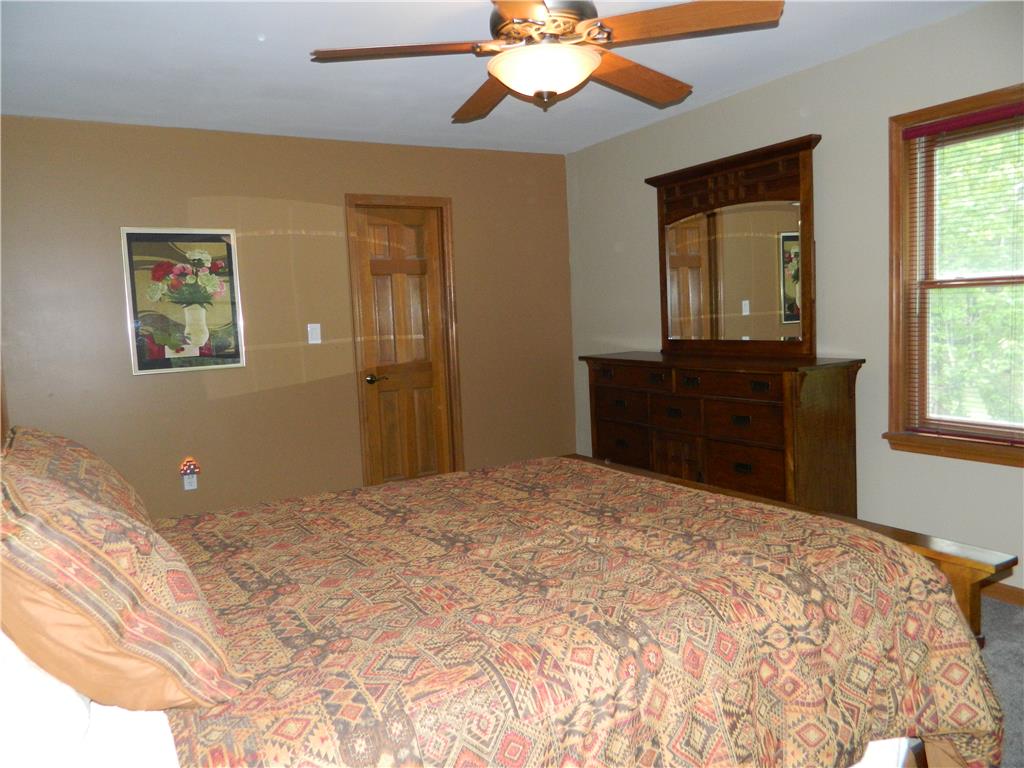 328 Pin Oak Road Stroudsburg, PA 18360 - Photo 22 of 37 A well-lit bedroom featuring wood-trimmed windows and a ceiling fan for comfort.
