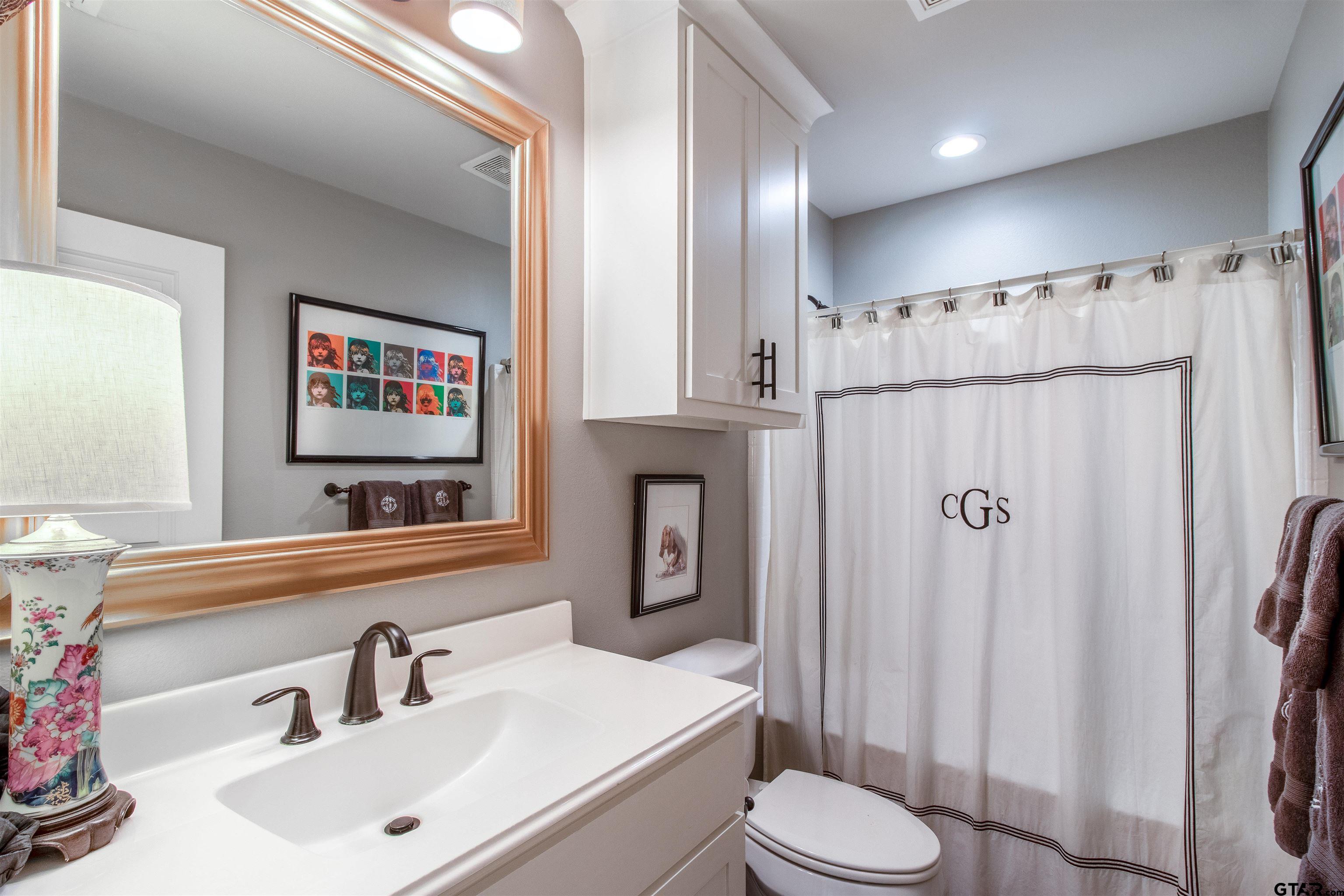14271 NW Road Tyler, TX 75707 - Photo 17 of 48 a bathroom with a sink toilet and shower
