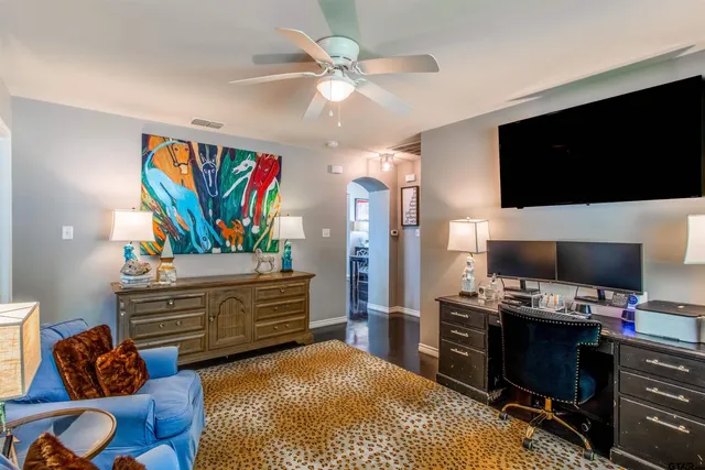 a bedroom with a bed and a television