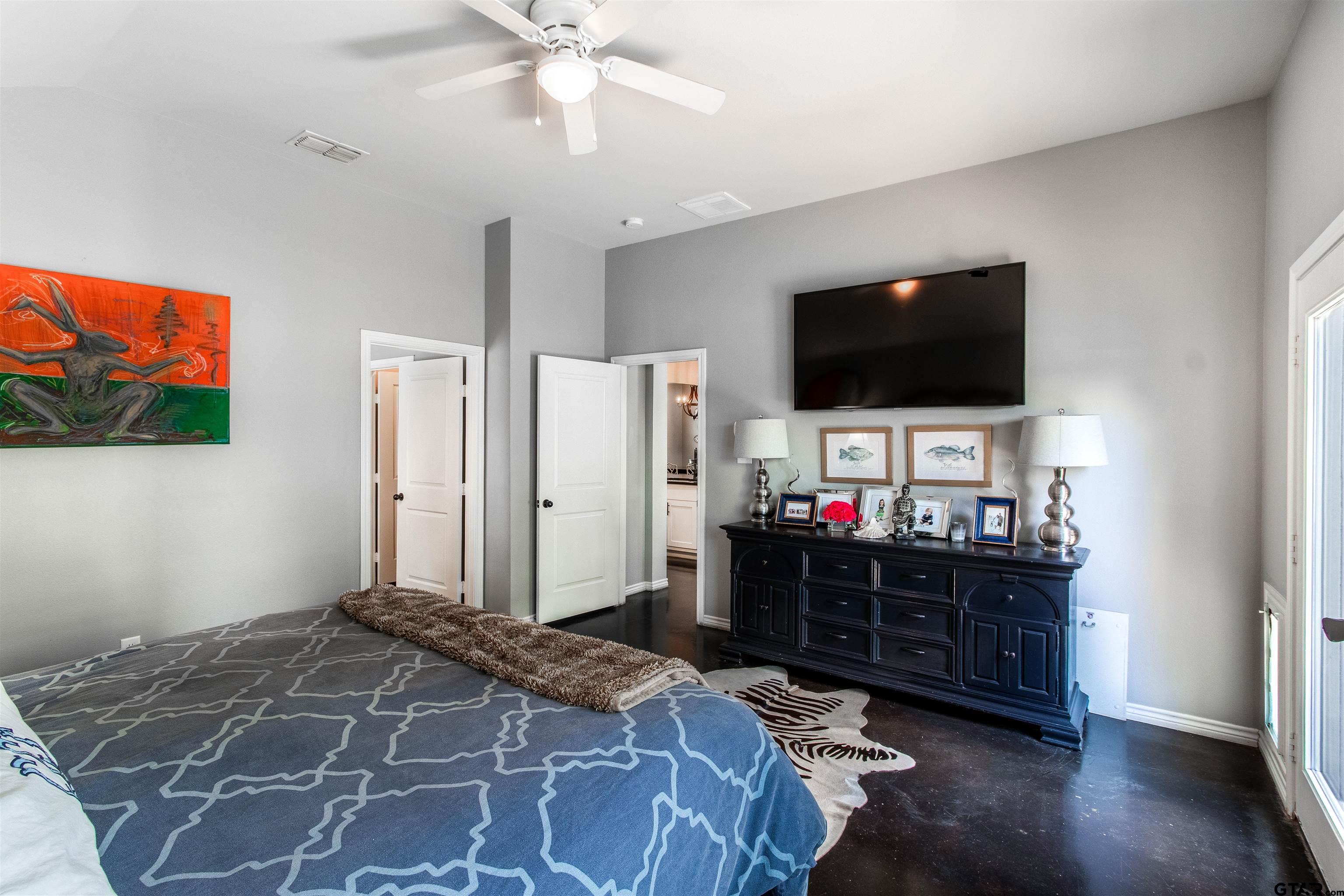 14271 NW Road Tyler, TX 75707 - Photo 25 of 48 a bedroom with a bed and a flat screen tv