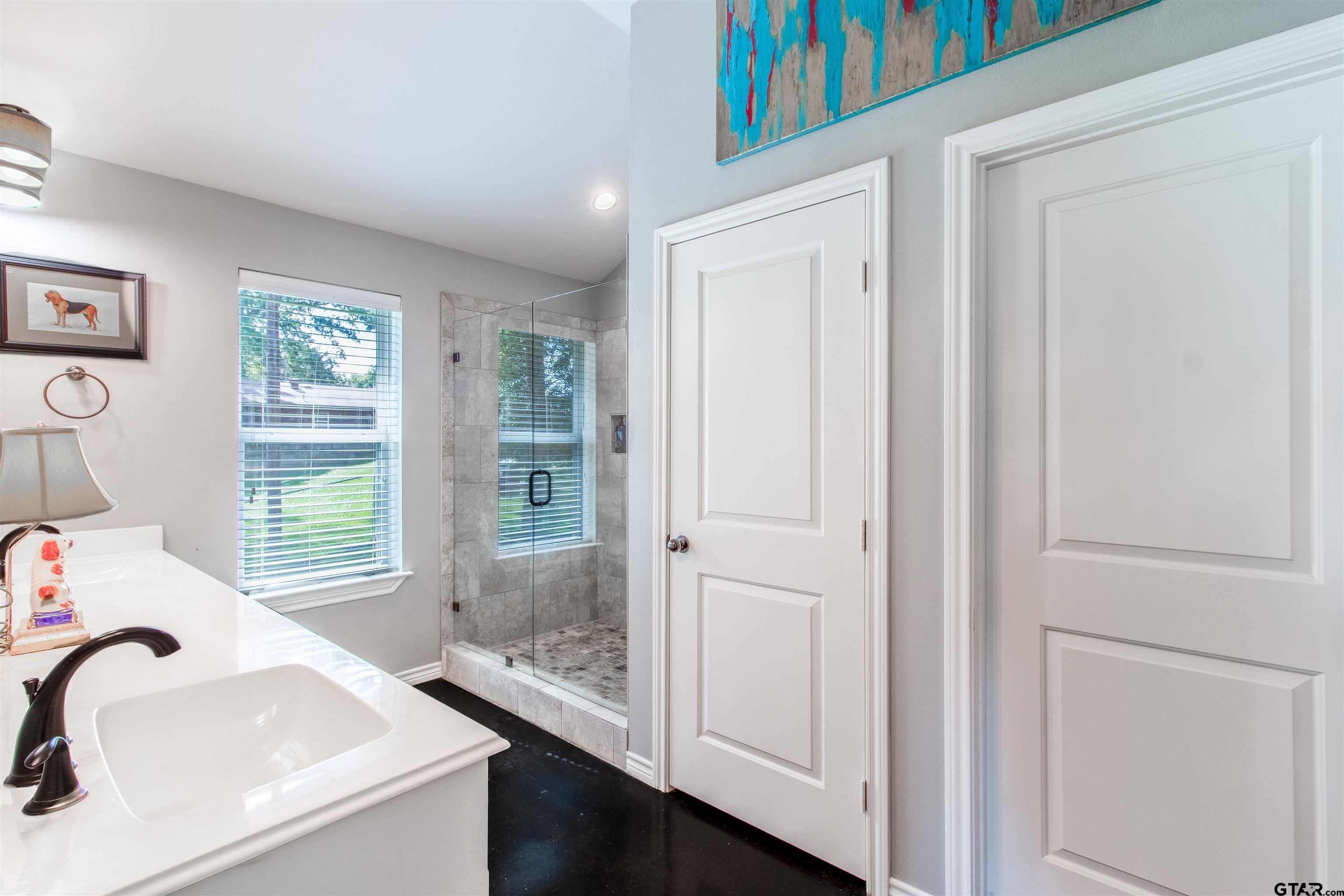 14271 NW Road Tyler, TX 75707 - Photo 26 of 48 a bathroom with a sink a bathtub and next to a window