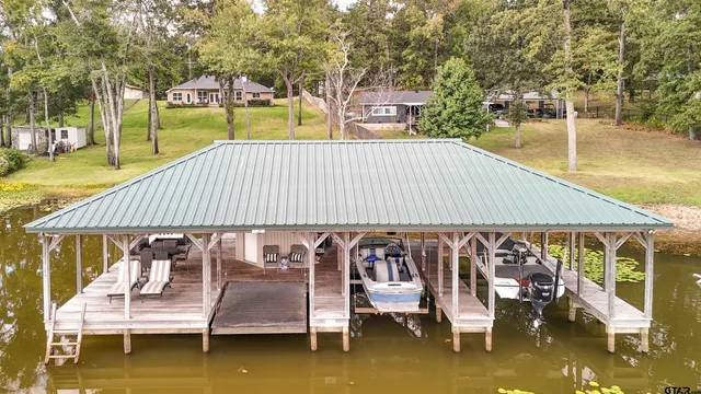 a roof deck with table and chairs under an umbrella