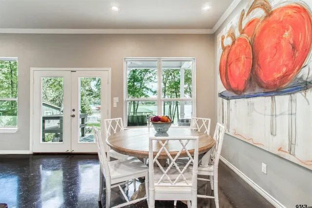 a dining room with furniture and wooden floor
