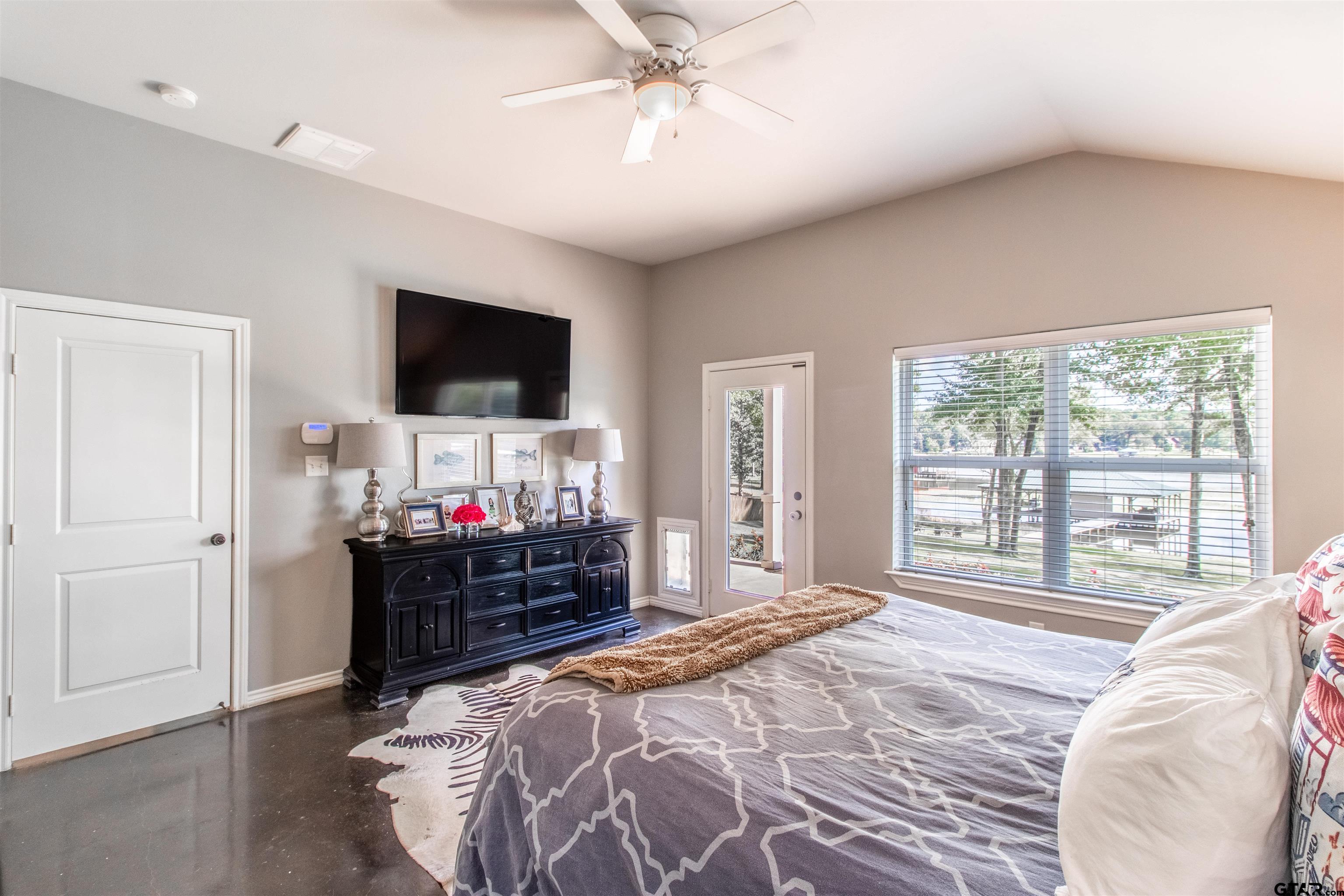 14271 NW Road Tyler, TX 75707 - Photo 10 of 48 a bedroom with a bed and a flat tv screen