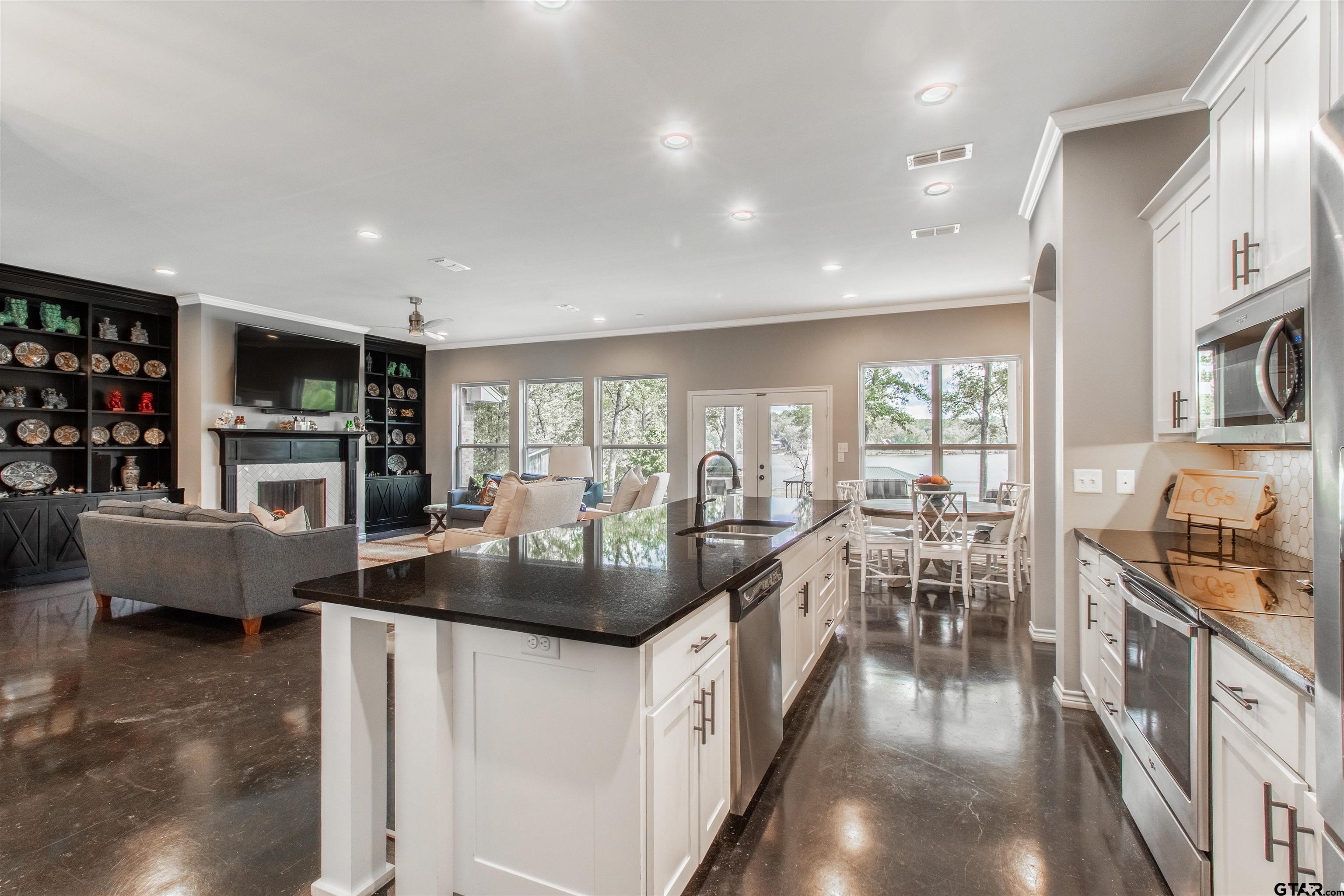 14271 NW Road Tyler, TX 75707 - Photo 10 of 48 a living room with furniture a flat screen tv and a floor to ceiling window