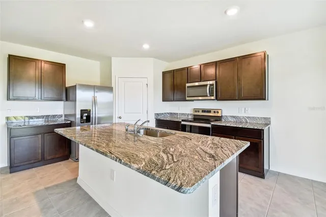 a kitchen with a stove a sink and a microwave
