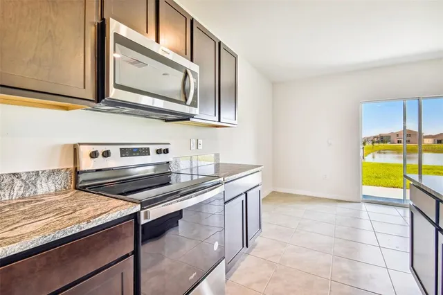 a view of a kitchen with a sink and a refrigerator