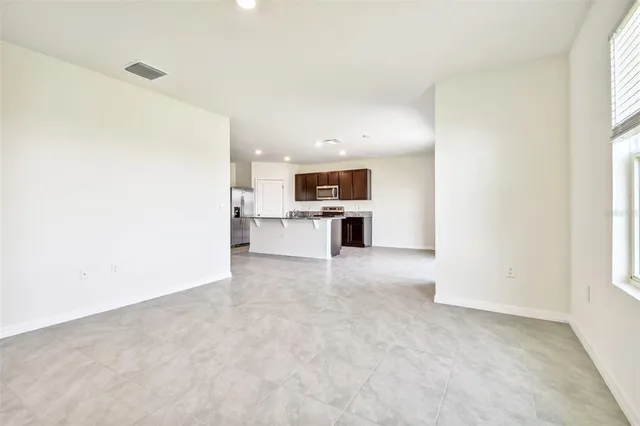 an empty room with closet and a bathroom
