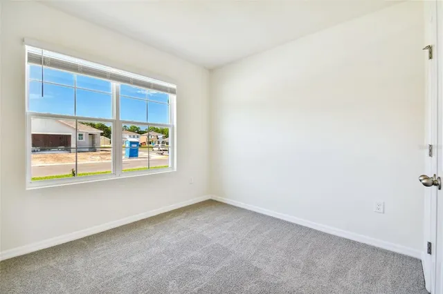 an empty room with windows and entrance