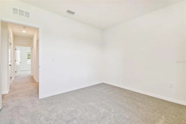 a bathroom with a granite countertop sink a toilet a mirror and shower