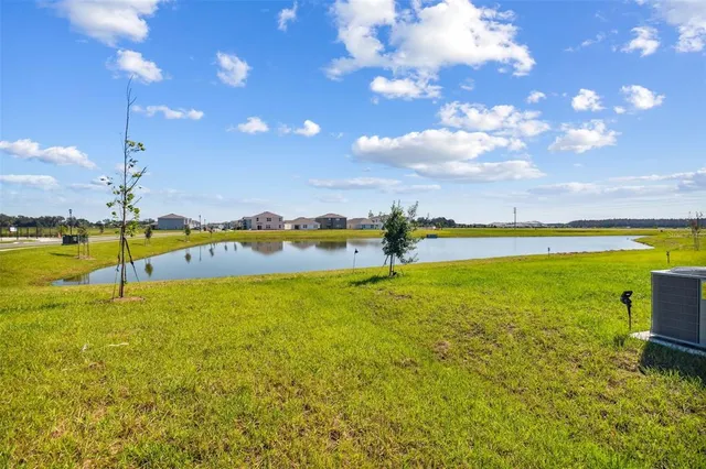 a front view of house with yard and garage