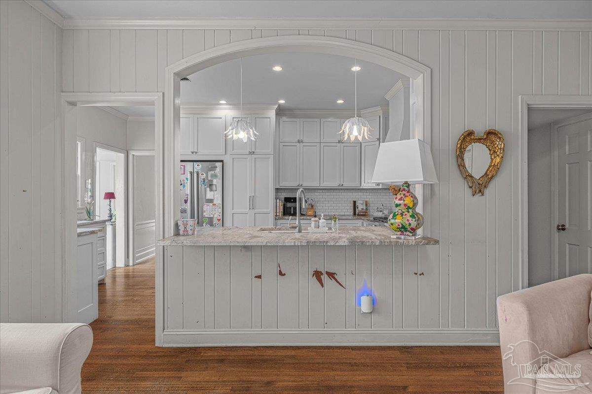 3361 Palermo Road Pensacola, FL 32503 - Photo 32 of 50 a living room with kitchen island furniture and a wooden floor