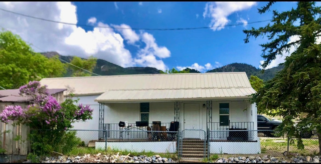 175 Eagle Street Eureka, UT 84628 - Photo 1 of 31 View of front of property featuring a porch, stucco siding, a mountain view, and a metal roof