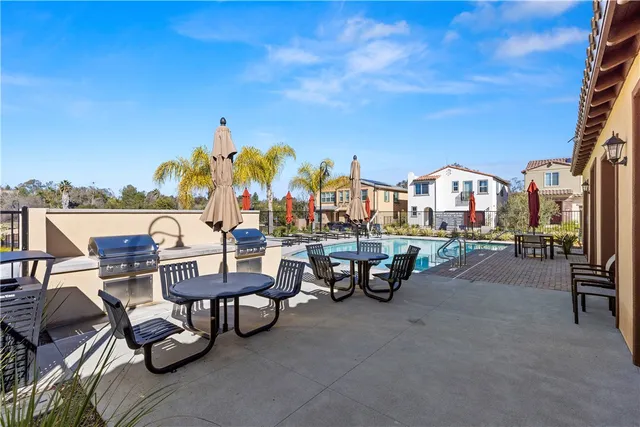 a view of a balcony with two chairs and a stove