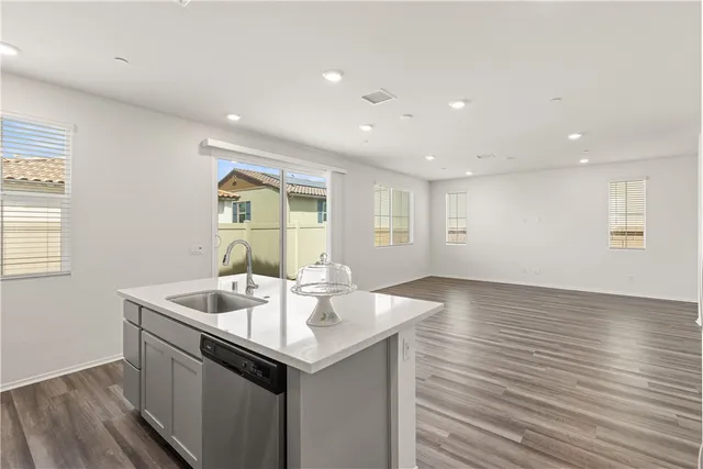 a kitchen with sink a microwave and refrigerator