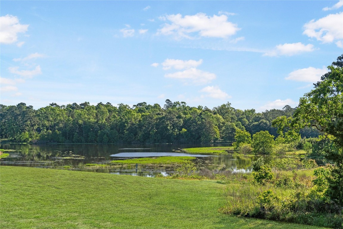42623 Rustico Road Magnolia, TX 77354 - Photo 14 of 17 a view of a lake with houses in the background