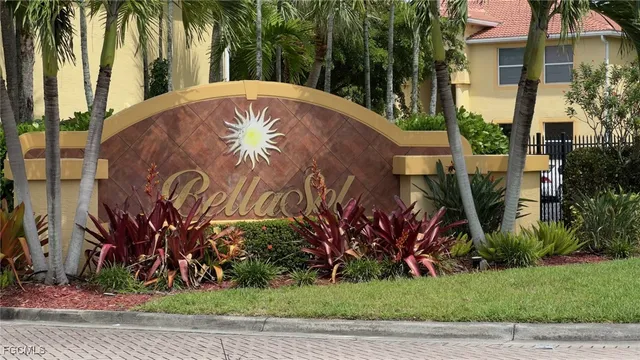 a view of a white house with a yard and potted plants