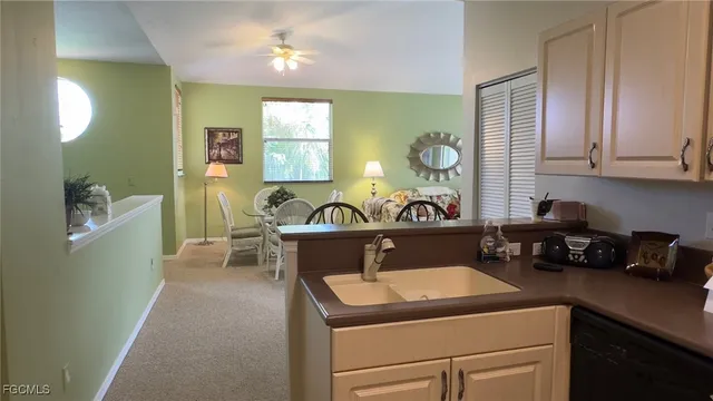 a kitchen with a sink cabinets and window