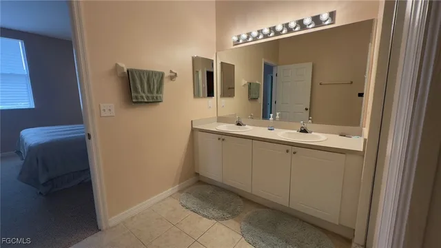 a bathroom with a double vanity sink and mirror
