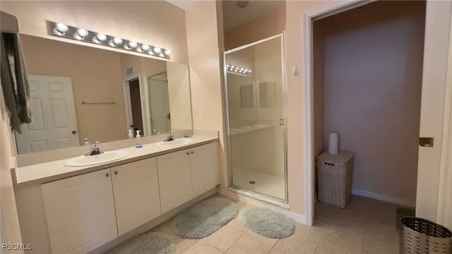a bathroom with a double vanity sink and mirror