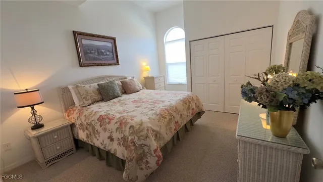 a bed room with a bed and a potted plant