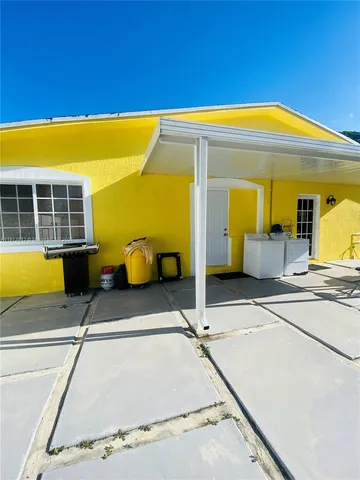 a view of a patio with a table and chairs